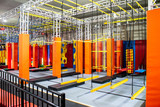 Fototapeta  - Brightly coloured interior ninja warrior parkour gym obstacle course with aerial netting