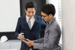 © Lab_Photo - Picture of successful two asian businessman is talking and using tablet in office and planning work new idea