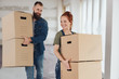 © contrastwerkstatt - Happy young couple carrying boxes into a new home