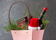 Christmas hamper with bottle of wine, gifts and festive goodies