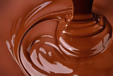 stream melt chocolate spreads in waves. hot cocoa background