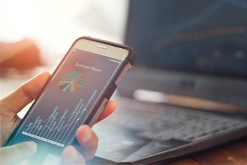 Leinwandbilder - Businessman using mobile smartphone analyzing sales data and economic growth graph chart. Business strategy. business report  Digital marketing.