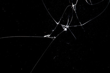 Poster - cracked glass isolated on a black background.