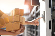 © ipopba - Delivery man holding parcel boxes and ring the doorbell on the client's door in the morning background.