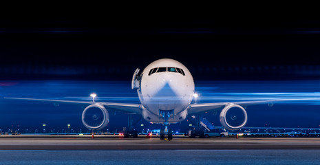 parked aircraft in night with moving light