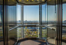 Transparent Glass Elevator With City View.