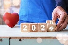 Doctor Hand Flip Over Wood Block With New Year 2020 And Goal Icon Healthcare, Achieving New Goals In The New Year.
