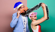 © be free - Manager tinsel celebrate new year. Corporate holiday party ideas. Christmas party office. Winter corporate party. Office christmas party. Happy man and woman wear santa hats and funny sunglasses