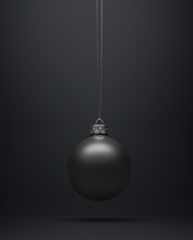 Matte Black Christmas Ball Hanging Centered On A Black Background.