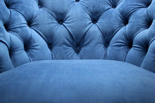 Detail Of Classical Furniture. Velour Armchair Close-up With Part Of The Seat. Blue Velvet With Buttons On The Upholstered Furniture.