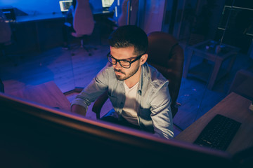 Poster - Photo of it specialist serious guy sitting chair seriously looking many monitors writing secure code for website calculate algorithms content development expert office indoors