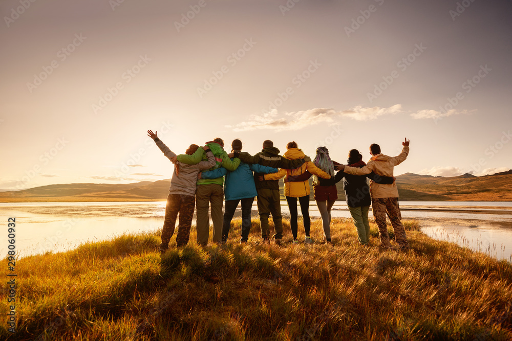 Happy big family hugging together in mountains - obrazy, fototapety, plakaty 