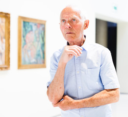 Man observing painting gallery