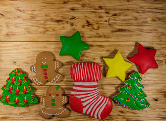 Wall Mural - Tasty festive Christmas gingerbread cookies on wooden table. Top view