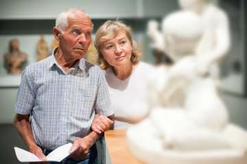 Wall Mural - Male and female pensioners visiting museum