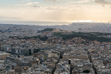 Sunset landscapes in Athens with ancient Acropolis and old city