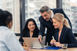 © ronnachaipark - Corporate business team and manager in a meeting.Young team of coworkers making great business discussion in modern coworking office.Teamwork people concept