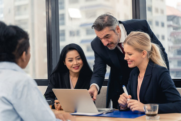 Corporate business team and manager in a meeting.Young team of coworkers making great business discussion in modern coworking office.Teamwork people concept