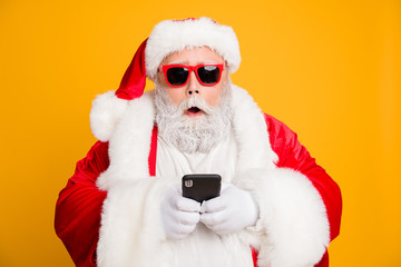 Poster - Omg tradition christmas discounts. Close up photo of impressed voiceless funky fat santa claus use smartphone find x-mas sales on internet wear red hat headwear isolated over shine color background