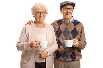 Wall Mural - Elderly couple having tea and smiling