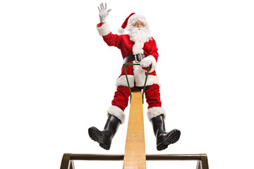 Canvas Print - Santa Claus on a seesaw smiling and waving