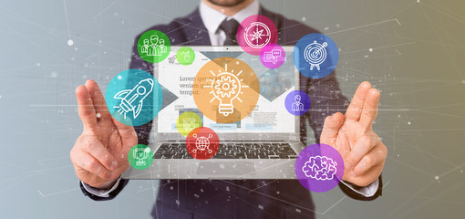 Poster - businessman holding a cloud of colorfull start up icon bubble with a laptop 3d rendering