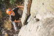 © Ramon Lopez/ADDICTIVE STOCK - From above man climbing a rock in nature with climbing equipment