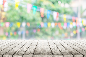 Wall Mural - Empty wooden table with party in garden background blurred.