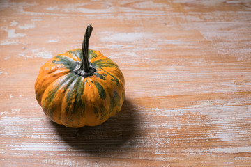 Poster - side view of orange pumpkin displayed on wooden surface