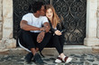 © Mosuno/Stocksy - Attractive interracial Young Black and White Couple, Smoking a Cigarettes