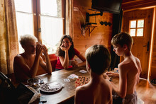 Stock Photo Of Four Kids Playing A Game Of Cards In The Summer In A Chalet
