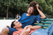 © Garage Island Crew/Stocksy - Happy young black couple sitting on the bench at the park
