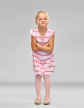 Childhood And People Concept - Displeased Little Girl In Red Shirt With Crossed Arms Pouting Over Grey Background