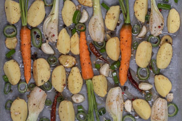 Roasted potatoes with grilled vegetables, carrots, peppers, onions and garlic. Summer healthy food. Closeup