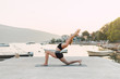 © Dimitrije Tanaskovic/Stocksy - Woman doing yoga by the sea