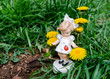 © Menta - Porcelain doll ceramic figurine - standing between yellow dandelion flowers and grass - frightened of a ladybug