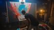 © Gorodenkoff - Talented Artist Working on Abstract Painting, Uses Paint Brush To Create Daringly Emotional Modern Picture. Dark Creative Studio Large Canvas Stands on Easel Illuminated.