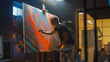 © Gorodenkoff - Talented Male Artist Energetically and Violently Draws with Paint Brush, He Creates Modern Masterpiece of the Oil Painting. Creative Studio with Large Canvas of Striking Colors. Back View Shot