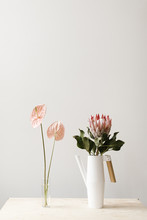Vase Of Light Pink Flowers And Watering Can With Large Flower