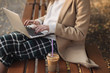 © AD Photography/Stocksy - Female Sitting On A Bench Using A Laptop
