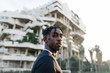 © Javier D?ez/Stocksy - Young African American man near modern building