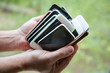 © Carolyn Lagattuta/Stocksy - Collection of old, used and broken cell phones