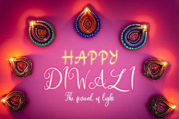 Wall Mural - Indian festival Diwali, Diya oil lamps lit on colorful rangoli. Hindu traditional. Happy Deepavali. Copy space for text.