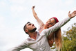 trait of excited funny funky two people look at sky space hold hand near eyes hug piggyback wear stylish trendy clothes. Happy couple piggybacking. 