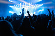 © Santi Nunez/Stocksy - Silhouettes of concert crowd in front of bright stage lights