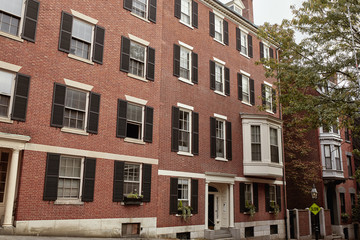 Beautiful brick residential buildings on a Fall day, in the historic Beacon Hill neighborhood of Boston, Massachusetts.