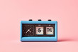 © Yaroslav Danylchenko/Stocksy - Flip clock with date calendar on a background, color of the year 2019 Living Coral pantone. Day Thusday, date 5, time is twenty two to five.