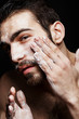 © leandro crespi/Stocksy - Man skincare sesion