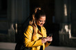 © Santi Nunez/Stocksy - Beautiful woman using a mobile in the street