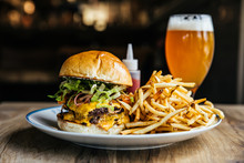 Double Cheeseburger With French Fries And A Beer